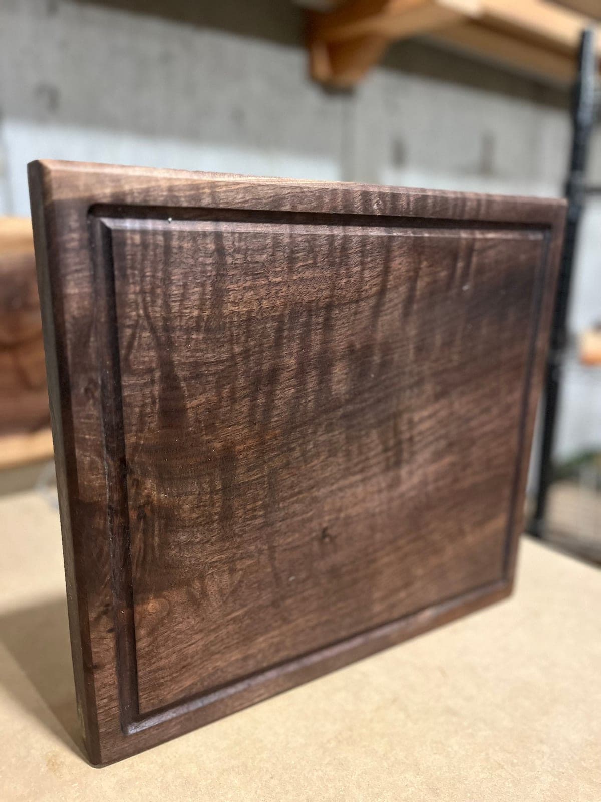 Dark figured wood cutting board with a juice groove